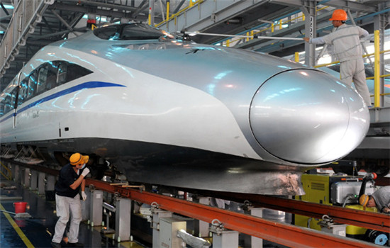 Workers check a bullet train locomotive manufactured by China Railway Rolling Stock Corp in Zhengzhou, Henan province. A CRRC subsidiary is considering a takeover of a Czech company to expand its market share in Europe. (LI BO / XINHUA)