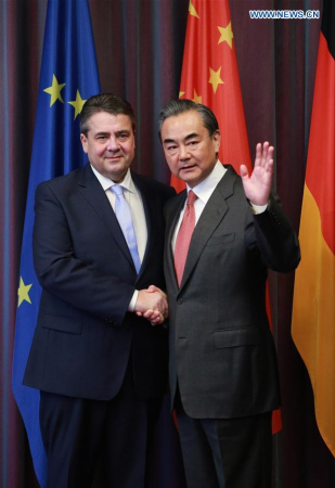 Chinese Foreign Minister Wang Yi (R) shakes hands with German Vice Chancellor and Foreign Minister Sigmar Gabriel in Bonn, Germany, Feb. 16, 2017. (Xinhua/Luo Huanhuan)